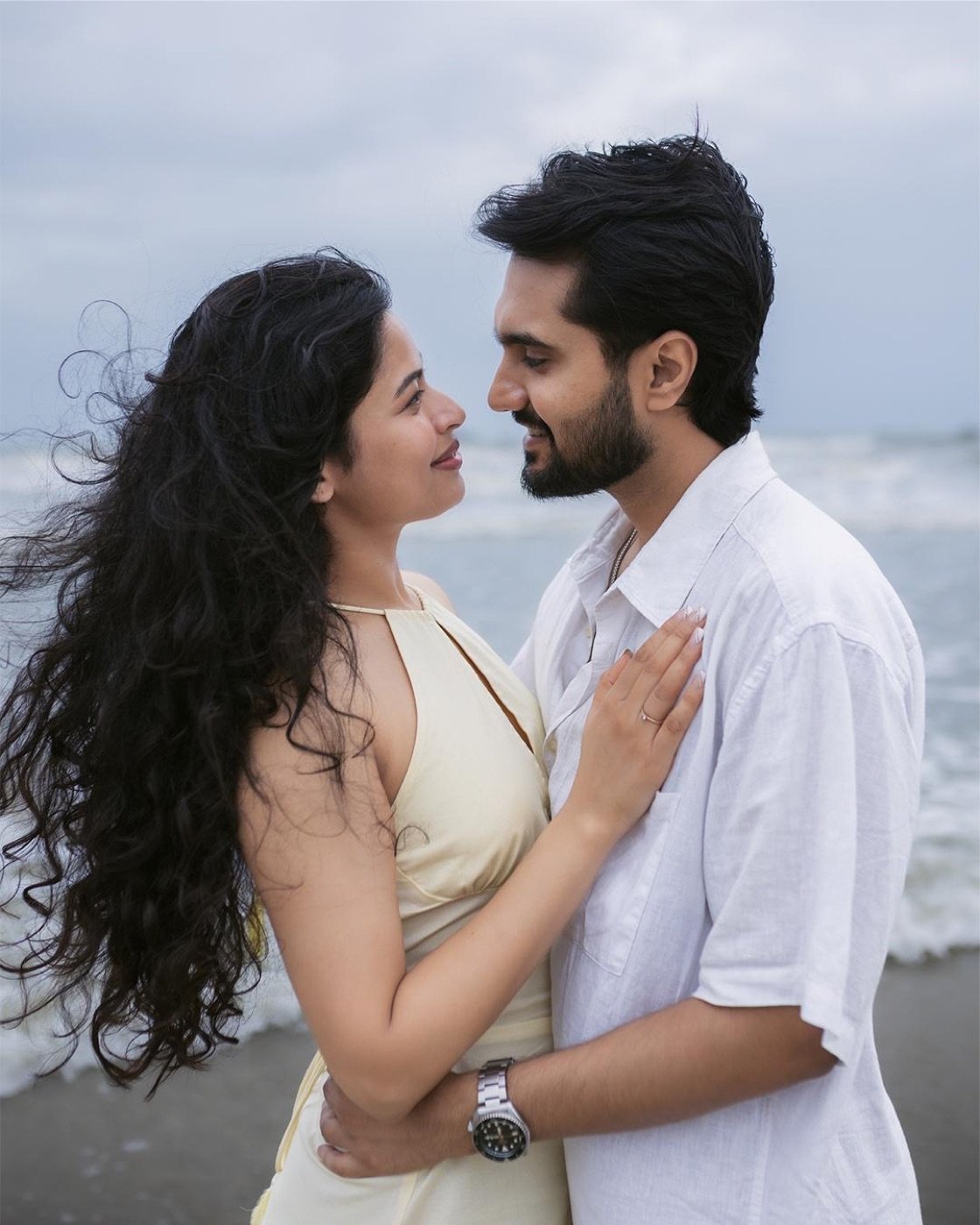 Face to face on the beach, wind in her hair